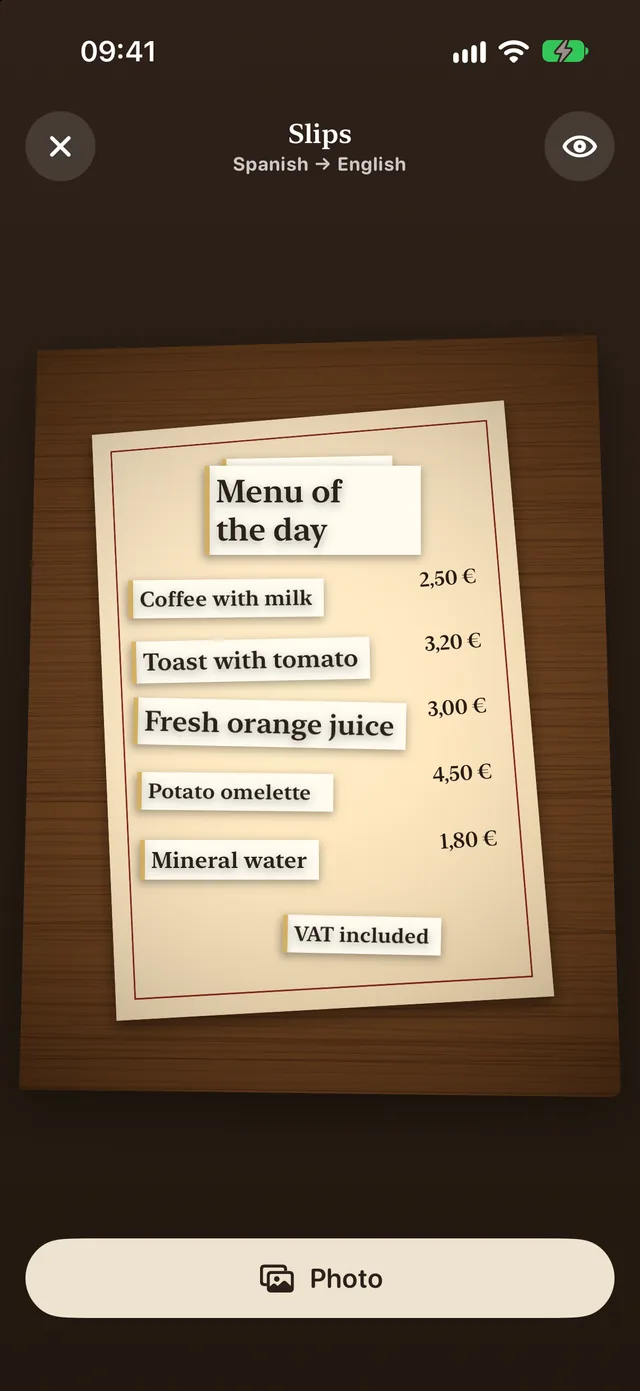 Slips (Pro): a photo of a Spanish café menu with a paper slip in English over each line, from Menu of the day and Coffee with milk to VAT included